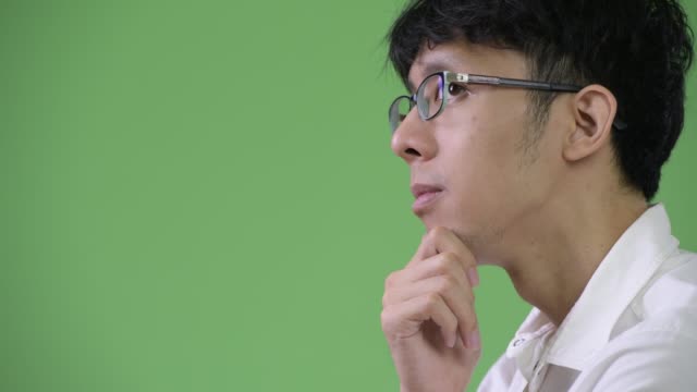 Profile-view-of-young-Asian-businessman-thinking