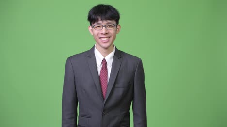 Young-happy-Asian-businessman-smiling