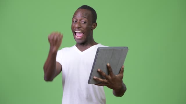 Young-happy-African-man-using-digital-tablet