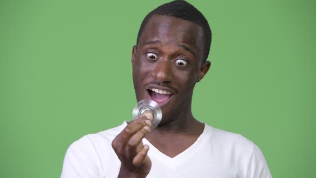 Young-happy-African-man-playing-with-fidget-spinner