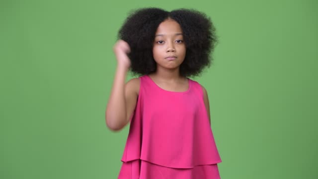 Young-cute-African-girl-with-Afro-hair-giving-thumbs-up