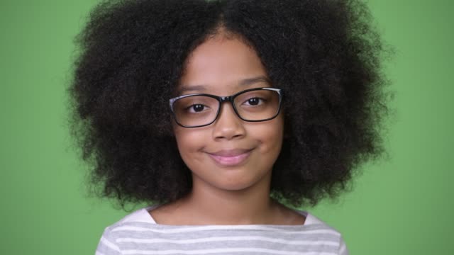 Joven-feliz-niña-africana-con-el-pelo-Afro-sonriendo-contra-el-fondo-verde