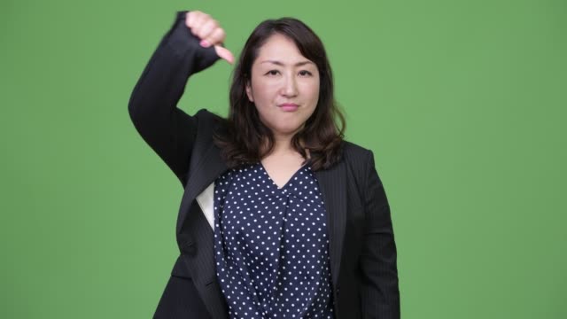 Mature-beautiful-Asian-businesswoman-giving-thumbs-down