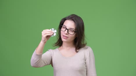 Mujer-hermosa-joven-jugando-con-spinner-de-fidget-y-centrándose