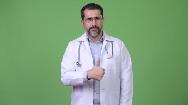 Handsome-Persian-bearded-man-doctor-giving-thumbs-up