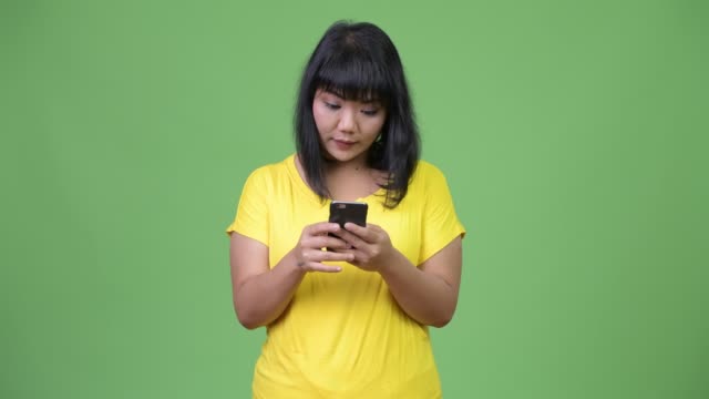 Beautiful-happy-Asian-woman-using-phone