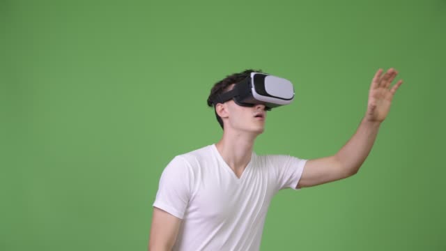 Young-handsome-man-using-virtual-reality-headset