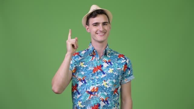 Young-handsome-tourist-man-pointing-finger-up