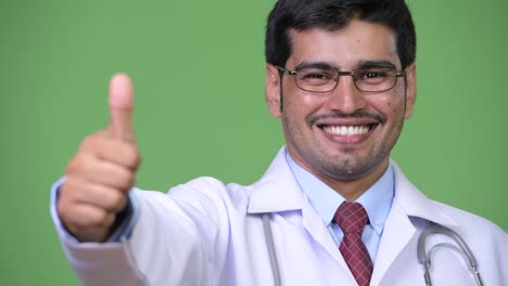 Young-handsome-Persian-man-doctor-thumbs-up