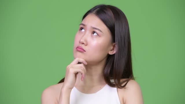 Young-beautiful-Asian-businesswoman-thinking