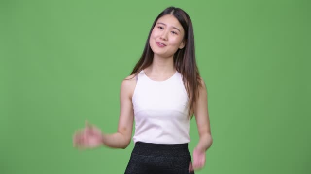 Young-beautiful-Asian-businesswoman-clapping-hands