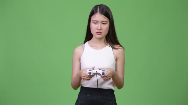 Young-beautiful-Asian-businesswoman-playing-games