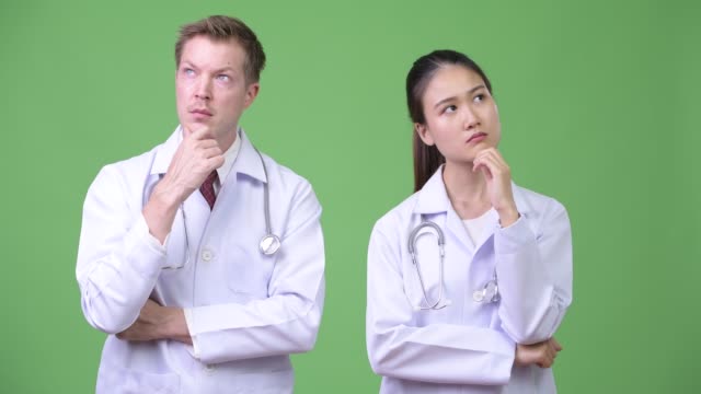 Multi-ethnic-couple-doctors-thinking-together