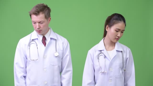 Serious-multi-ethnic-couple-doctors-thinking-together