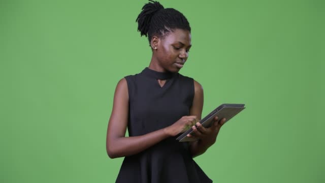 Young-beautiful-African-businesswoman-using-digital-tablet