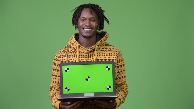 Young-handsome-African-man-showing-laptop