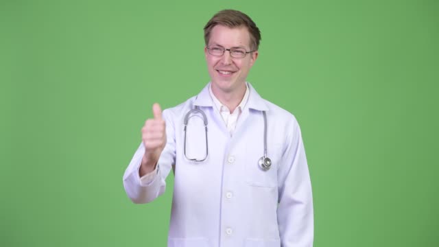 Young-Man-Doctor-Making-Thumb-Up-Gesture