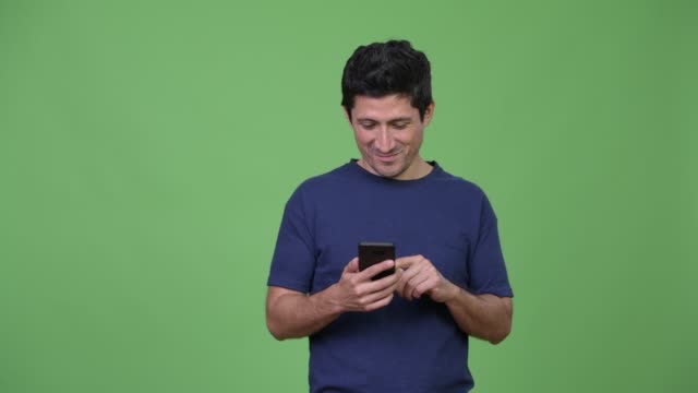 Happy-Hispanic-man-using-phone