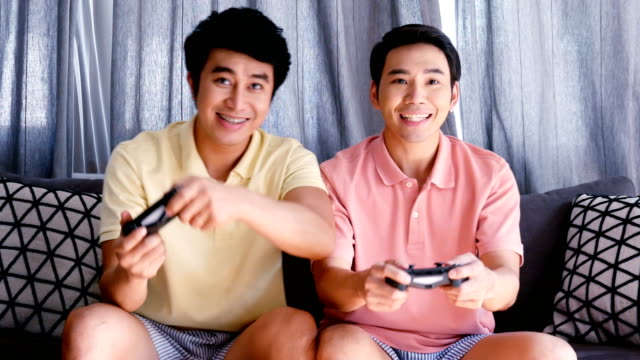 Gay-couple-playing-game-together-with-happy-emotion.-People-with-gay,-homosexual,-lifestyle-and-relationship-concept.