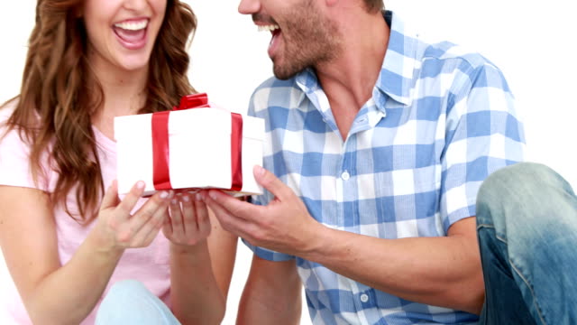 Smiling-man-offering-gift-to-his-girlfriend