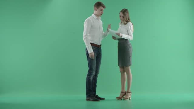 Angry-Businesswoman-Scolding-Her-male-Colleague-And-Throwing-Papers-Up-In-Air-on-a-green-screen