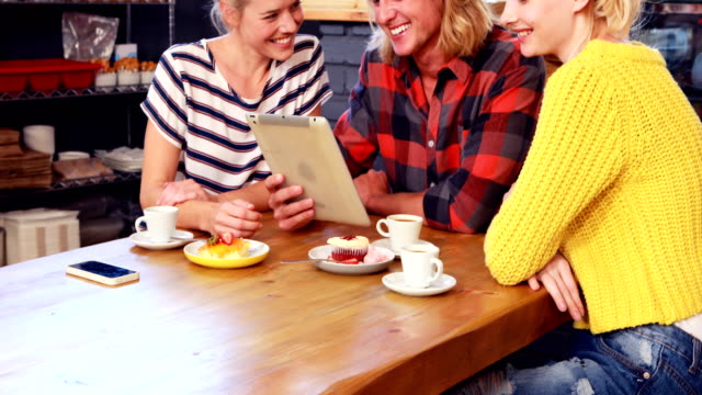 Smiling-friends-looking-at-tablet