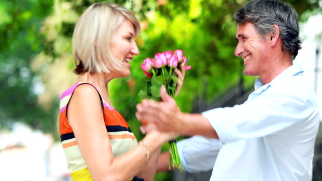 Man-giving-flowers-to-a-woman