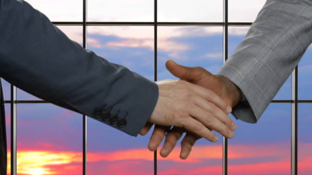 Geschäft-Handshake-bei-Sonnenuntergang-Hintergrund.