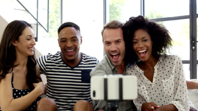Multi-ethnic-friends-smiling-and-taking-selfie