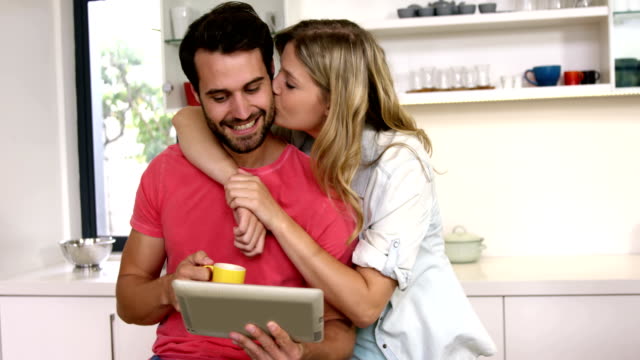 Happy-couple-using-technology