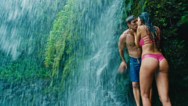 Couple-Relaxing-Under-Waterfall