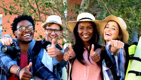 Hipster-students-are-smiling-to-the-camera-with-thumbs-up