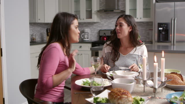 Lesbian-couple-having-a-romantic-dinner-in-their-kitchen,-shot-on-R3D