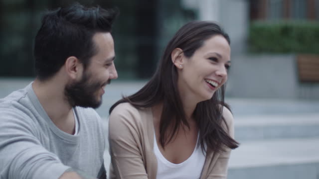 Young-Happy-Smiling-Man-and-Woman-are-Communicating-Outdoors.-Slow-Motion-Shot.
