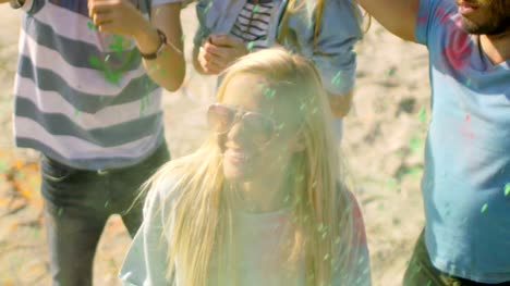 High-Angle-Shot-of-a-Blonde-Girl-Throwing-Colorful-Powder-in-the-Crowd-Amidst-Hindu-Holi-Festival-Celebrations.-They-Have-Enormous-Fun-on-this-Sunny-Day.