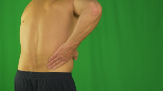 Man-rubbing-by-palm-hand-his-lower-back-due-pain-in-back.