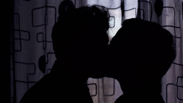 Silhouette-of-men-kissing-in-the-mouth.-Portrait-of-gay-kiss