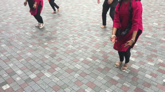 Unrecognizable-Indian-people-dancing-in-the-street