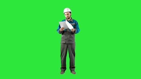 Engineer-Man-Verify-and-Read-Files-Documents-on-a-Green-Screen,-Chroma-Key