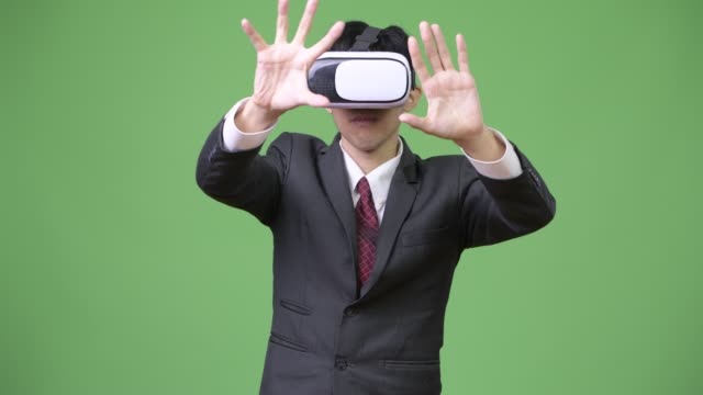 Young-Asian-businessman-using-virtual-reality-headset