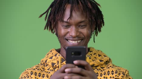 Young-happy-African-man-using-phone