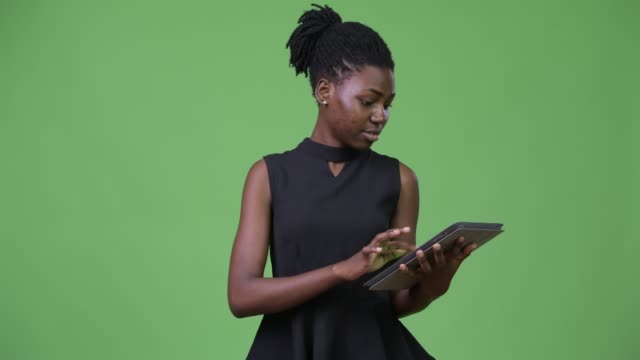 Young-beautiful-African-businesswoman-using-digital-tablet