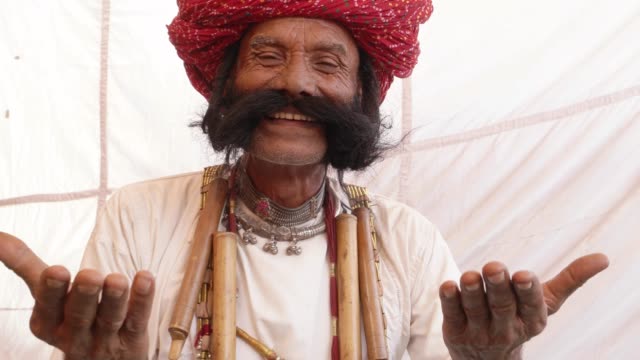 Smiling-man-from-Rajasthan-with-big-moustache-and-hands-joined-in-namaste-welcoming-guests