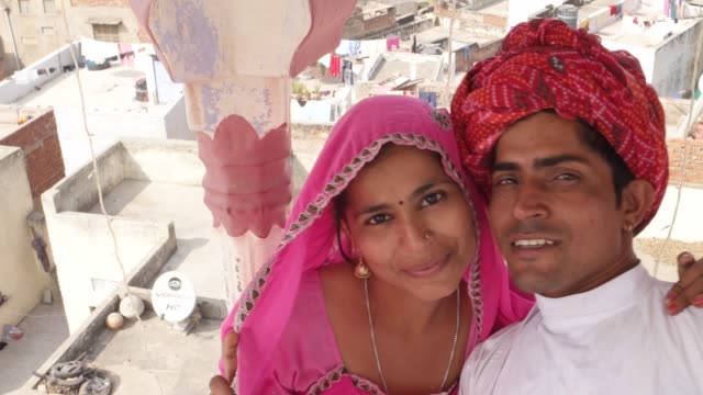 POV-of-selfie-stick-camera-taking-photo-and-video-of-Indian-bride-and-groom-in-India