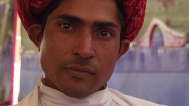 Portrait-of-a-Rajasthani-young-male-in-red-turban-in-Pushkar,-India