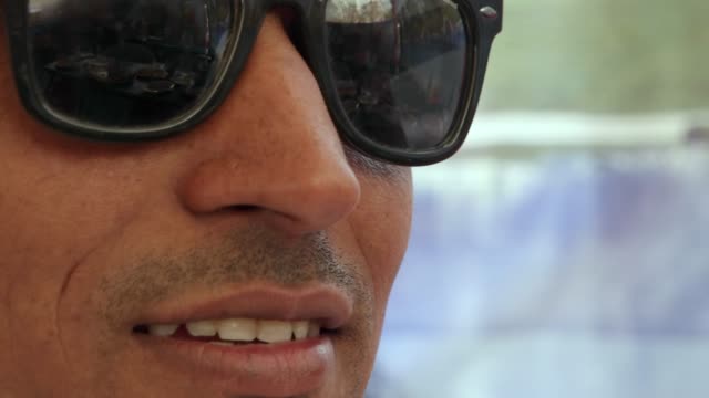 Extreme-closeup-of-a-handsome--dude-male-wearing-dark-glasses,-smug,-sexy-and-confident-in-Rajasthan,-India