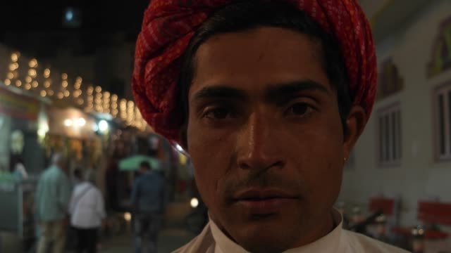 Portrait-of-an-Indian-man-wearing-traditional-Rajasthani-clothes-and-red-turban-at-night
