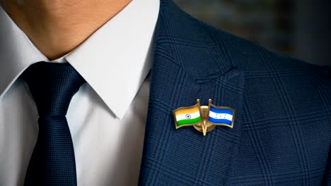 Businessman-Walking-Towards-Camera-With-Friend-Country-Flags-Pin-India---Honduras