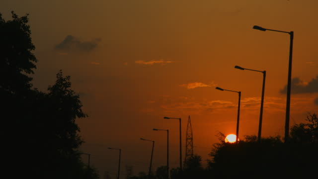 Locked-on-shot-of-street-lights-at-sunset,-Delhi,-India