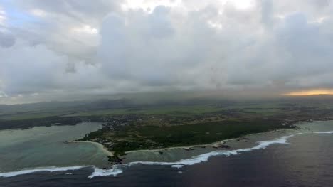 Aerial-shot-of-Mauritius-with-low-clouds-and-blue-lagoons